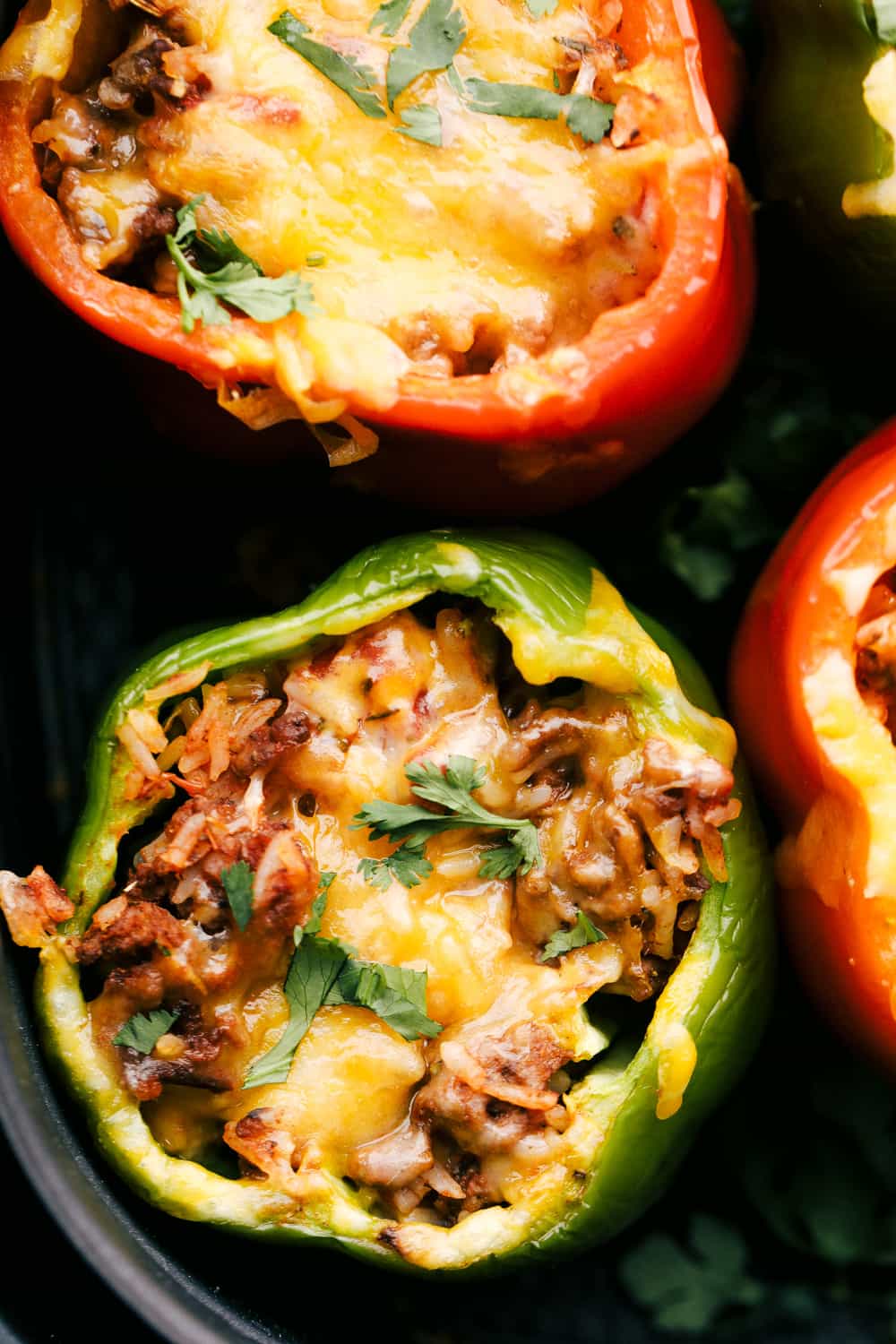 A super easy and delicious dinner begins here with Air Fryer Stuffed Peppers. Filled with a savory mixture and cooked to tender perfection, it is going to be a family favorite! Air fried stuffed peppers.
