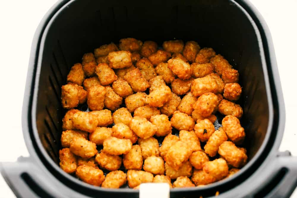 Air Fryer Tater Tots are just about the greatest thing to happen to potatoes ever! Crispy golden on the outside and tender on the inside, these are insanely delicious! Crispy golden air fried tater tots.