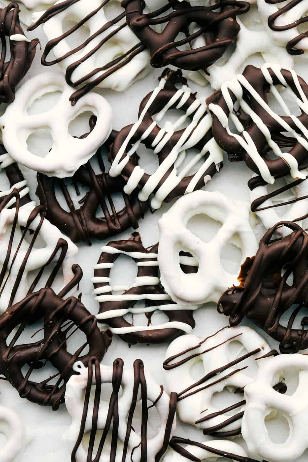 Chocolate Covered Pretzels are fast, easy and delicious! A perfect sweet and salty treat that's perfect for parties, holidays or any special occasion. White and Dark chocolate covered pretzels.