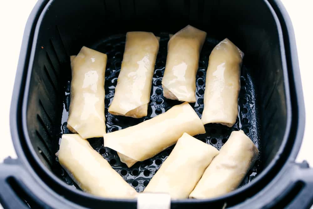 Egg Roll lovers, this Crispy Air Fryer Egg Roll Recipe is for you! Crispy, crunchy outside, tender filling inside, without the extra fat of frying or drying out from oven cooking. These are what you have been waiting for! Egg rolls ready to air fry.