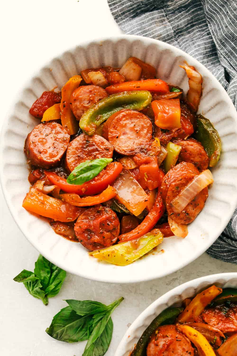 Apparently garlic fixes everything, and you knew it before I did. After a few of you suggested adding it to this Italian Sausage & Peppers, I gave it a tryโฆ and wow! Turns out, garlic takes this from good to seriously addictive. Skillet Italian sausage and peppers in a white bowl.