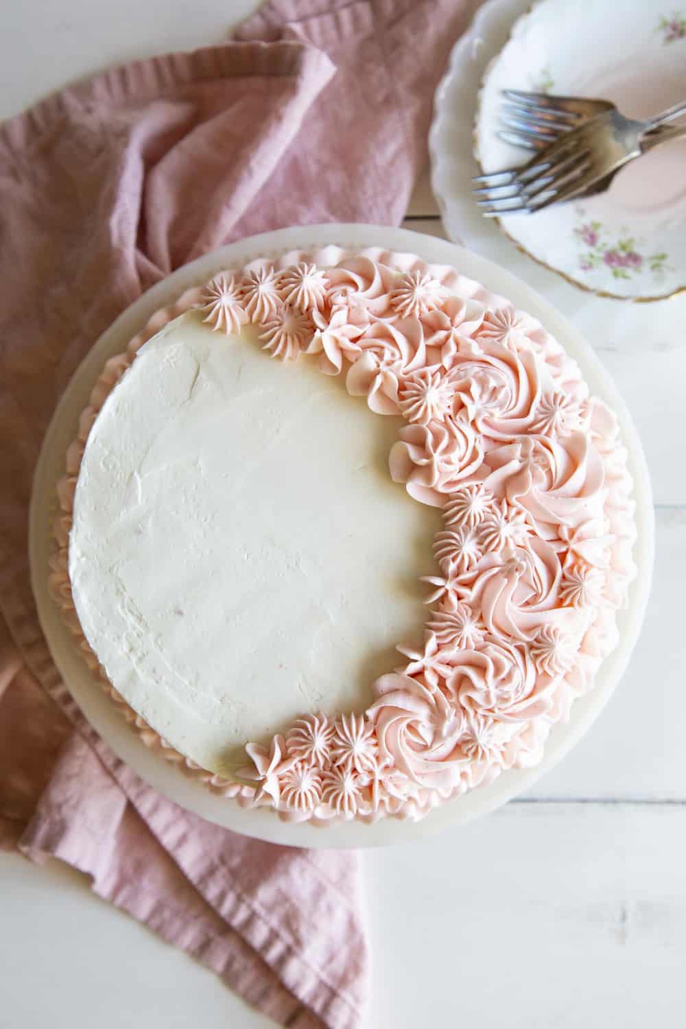 This rich decadent Pink Velvet Cake is going to be a quick favorite.It's absolutely perfect for Valentine's Day, baby showers or any other special occasions. Pink velvet cake with white frosting and pink flowers.