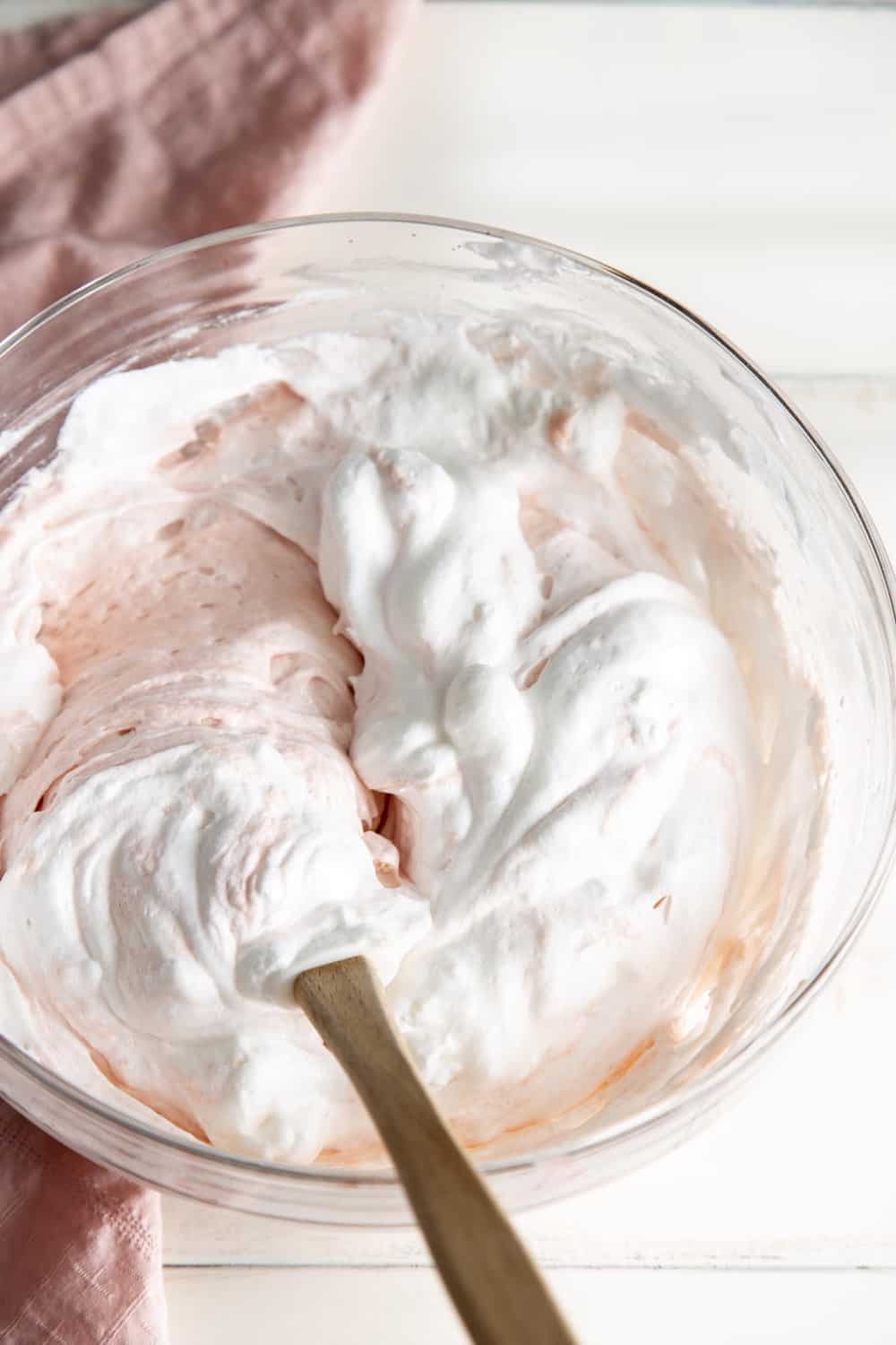 This rich decadent Pink Velvet Cake is going to be a quick favorite.It's absolutely perfect for Valentine's Day, baby showers or any other special occasions. Folding i n the meringue with the cake batter.