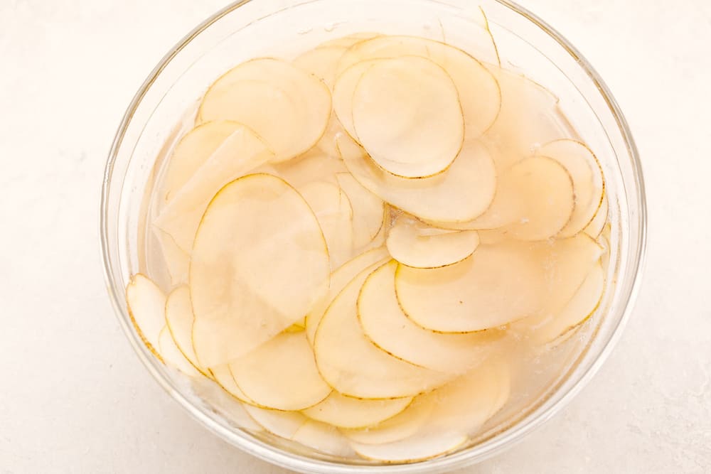 Air Fryer Potato Chips are a chip lovers dream come true! Now you can have all the chips, and none of the guilt! Soaking sliced potatoes in water.