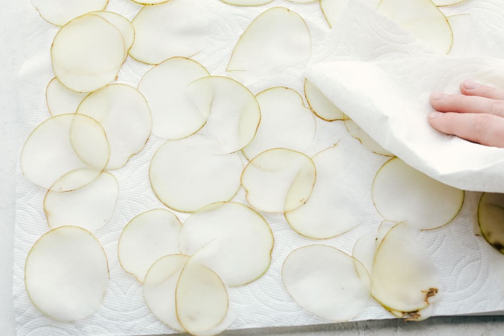 Air Fryer Potato Chips are a chip lovers dream come true! Now you can have all the chips, and none of the guilt! Drying the potato slices with paper towel.