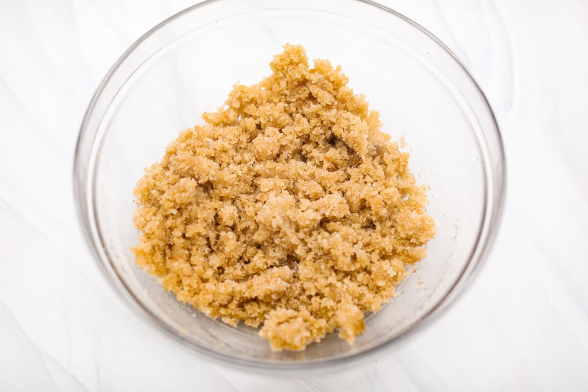 My carrot cake bars are so easy to make and unbelievably delicious. They are moist from the freshly grated carrots, perfectly spiced, and topped with an incredibly fluffy cream cheese frosting. Overhead shot of sugars and oil mixed together in a bowl.