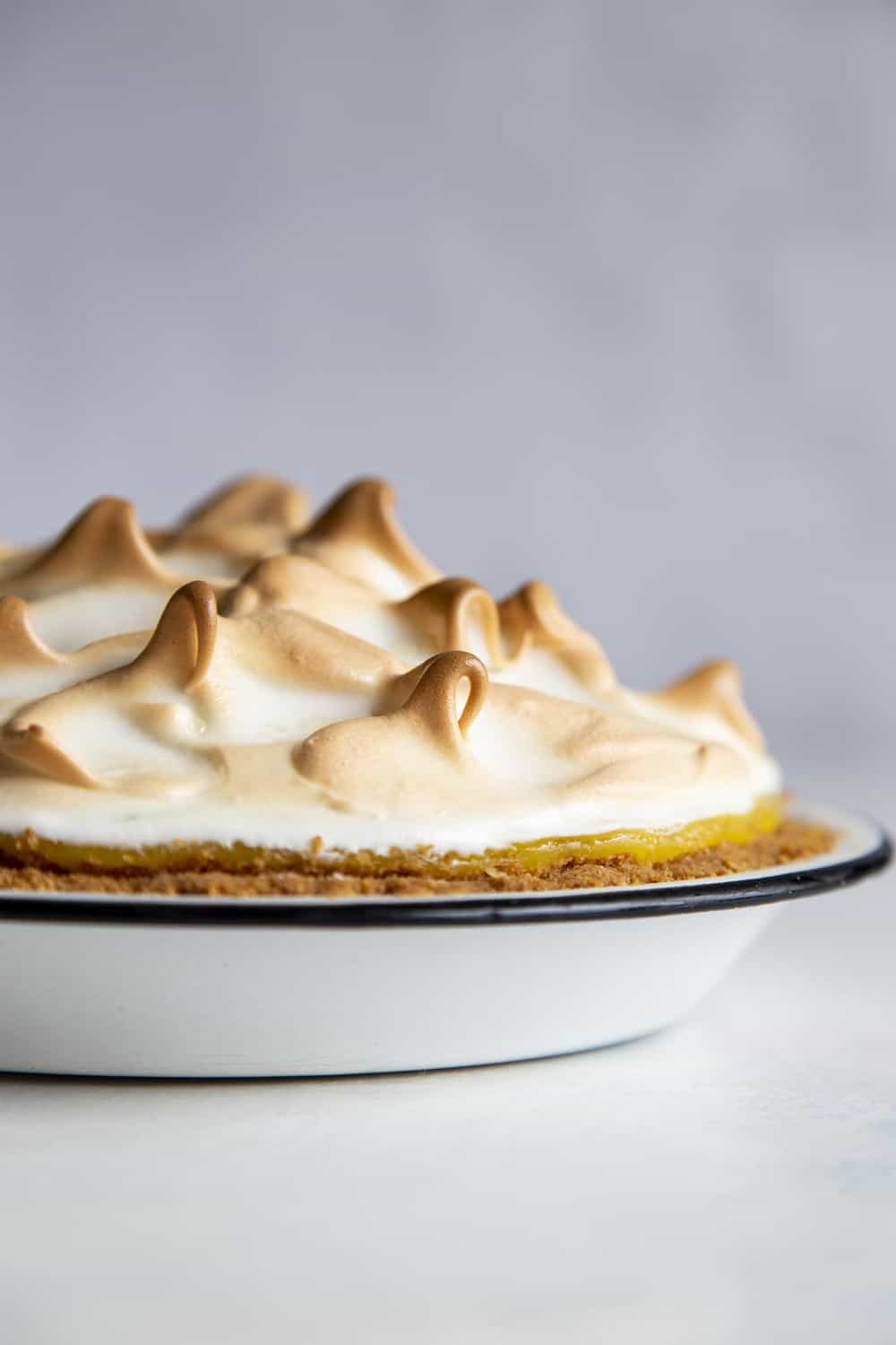 Lemon Meringue Pie is literally a slice of sunshine! Tart and tangy, bright lemon filling is topped with clouds of fluffy meringue that is going to blow your taste buds. Baked Lemon Meringue pie with a golden top.