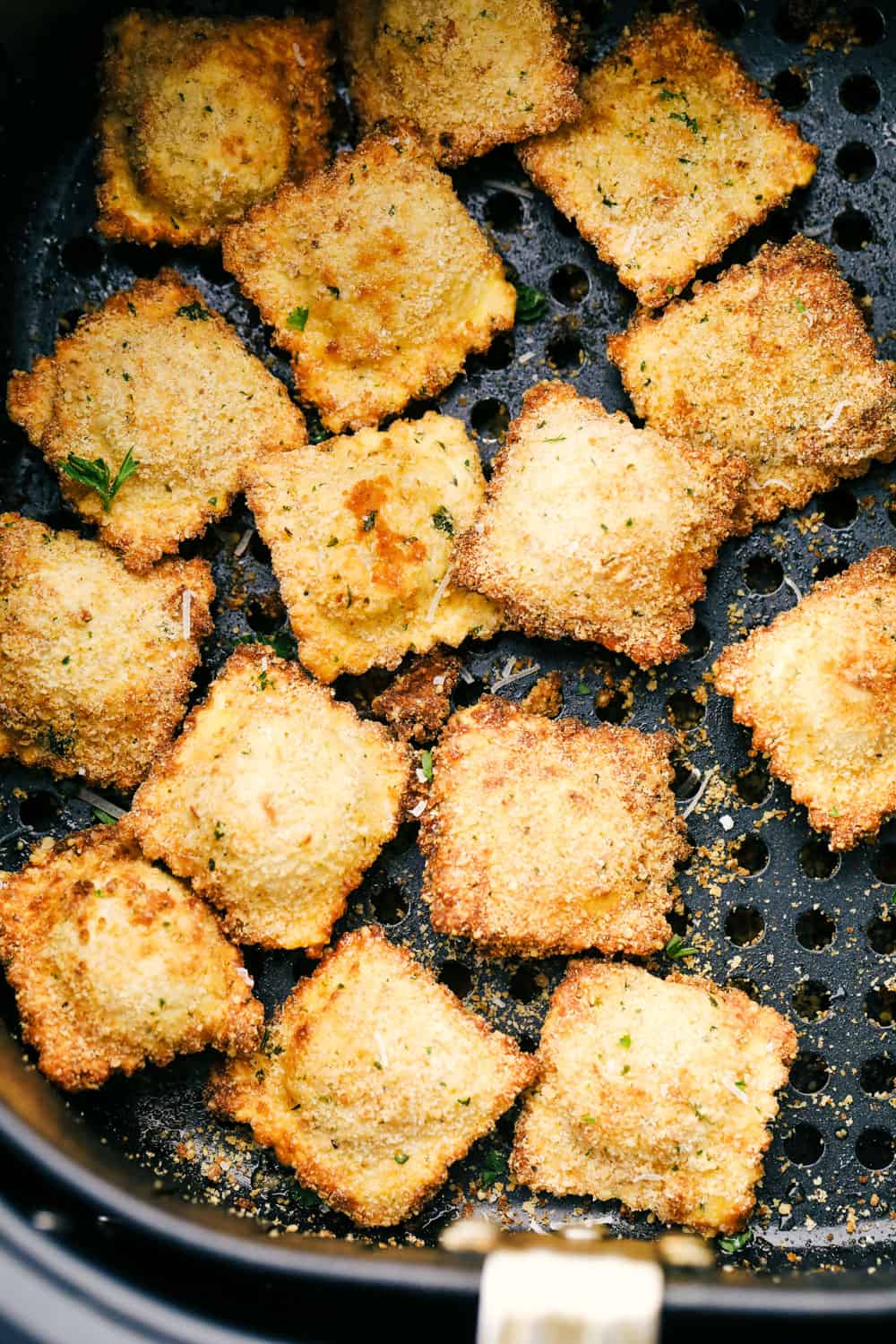 Air Fryer Toasted Ravioli are crispy golden nuggets of YUM!ย Perfect as an appetizer or even a meal, you are going to love these! Air fryer ravioli in the air fryer basket.