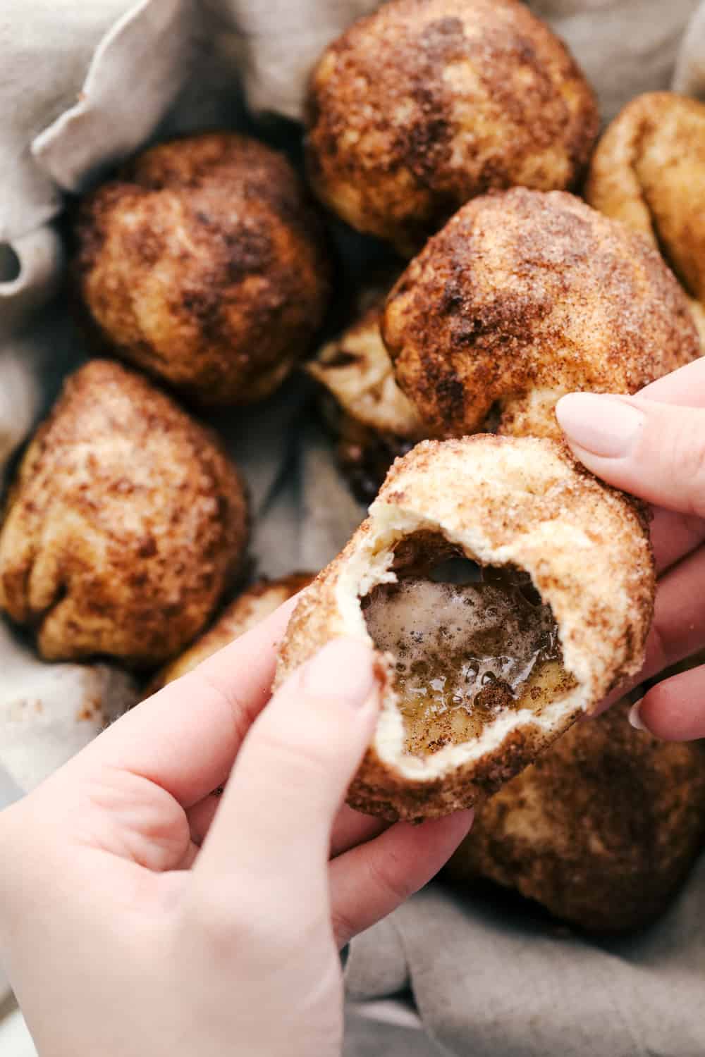 Empty Tomb Rolls are the perfect treat for Easter. Whether you have them for breakfast, brunch or dessert, they will be a huge hit! Opening an empty tomb roll to reveal the melted marshmallow goodness.