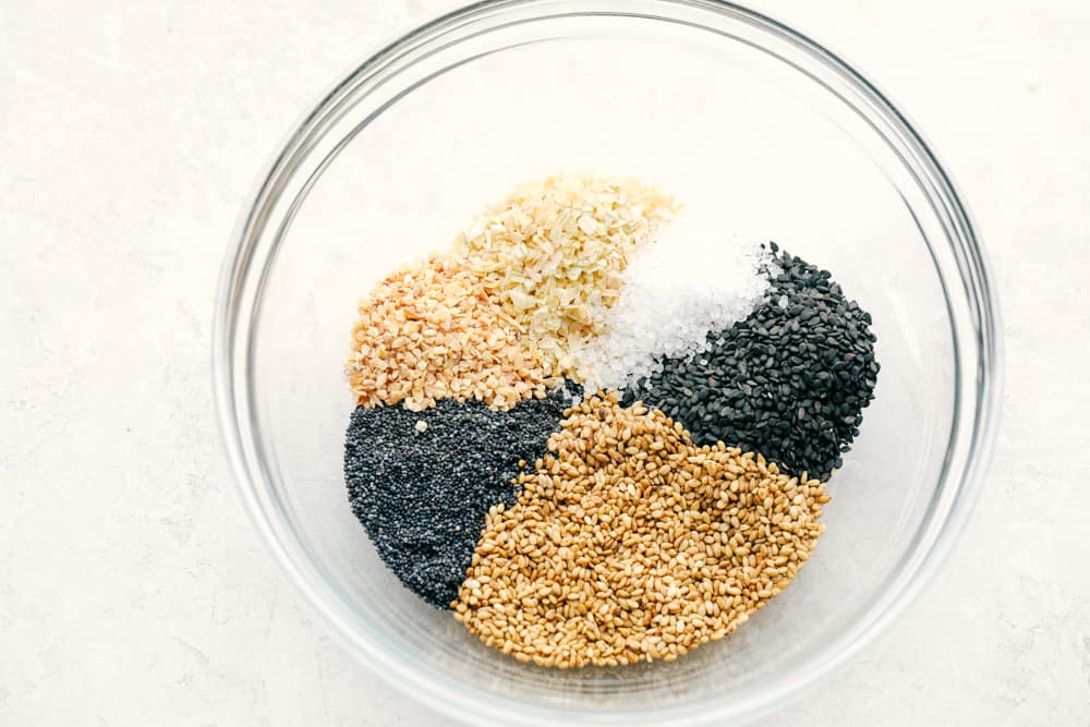Everything Bagel Seasoning made at home takes 6 ingredients and less than 5 minutes! You are going to love this super easy and fast divine seasoning. All the ingredients in a bowl separated.