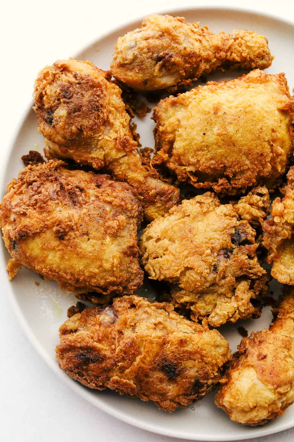 The Best Fried Chicken is literally at your fingertips! Way easier than you think and this fried chicken tastes even better than famous Roscoe's Chicken! Perfectly golden fried chicken on a plate.