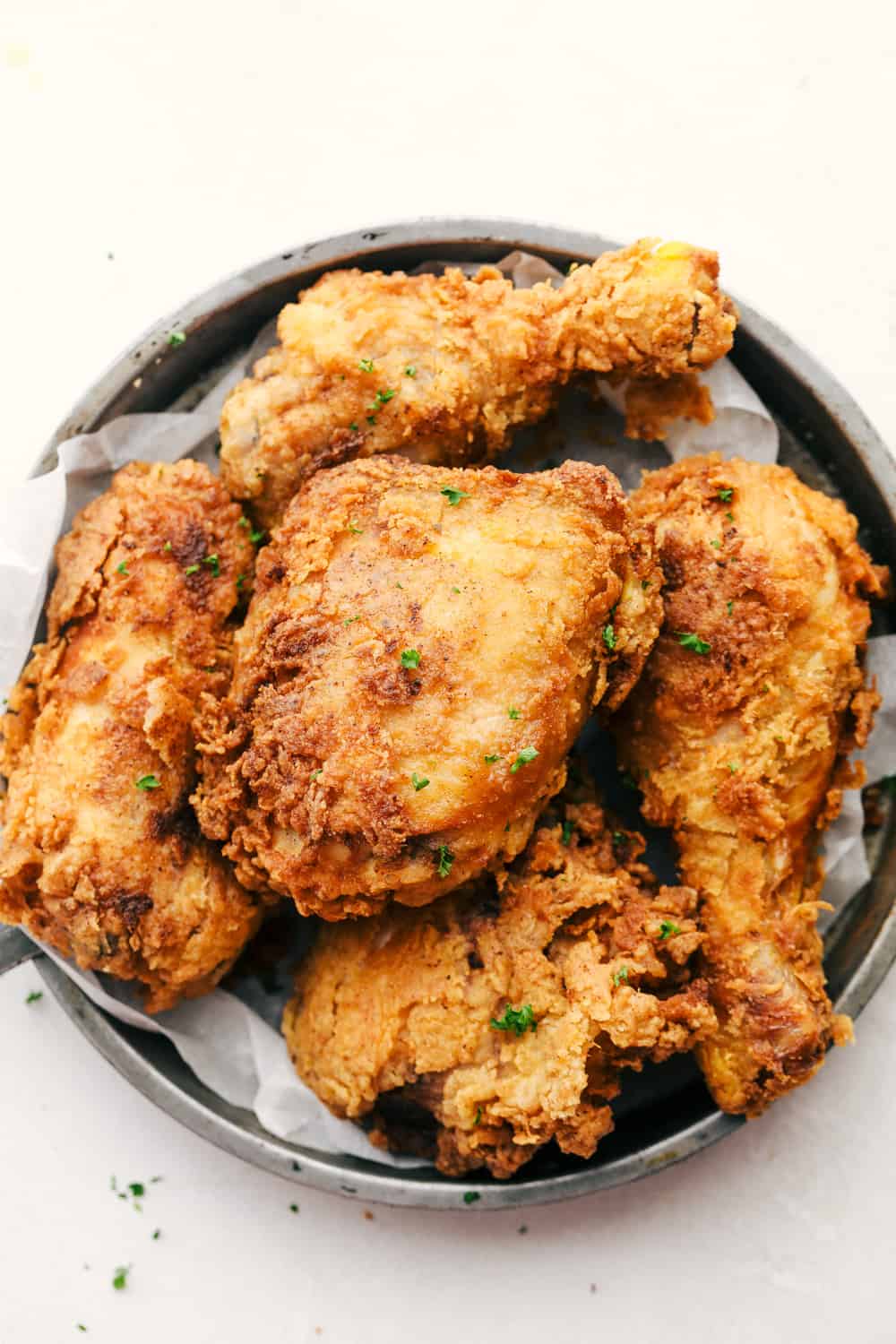 The Best Fried Chicken is literally at your fingertips! Way easier than you think and this fried chicken tastes even better than famous Roscoe's Chicken! Crispy, crunchy and juicy fried chicken on a plate.