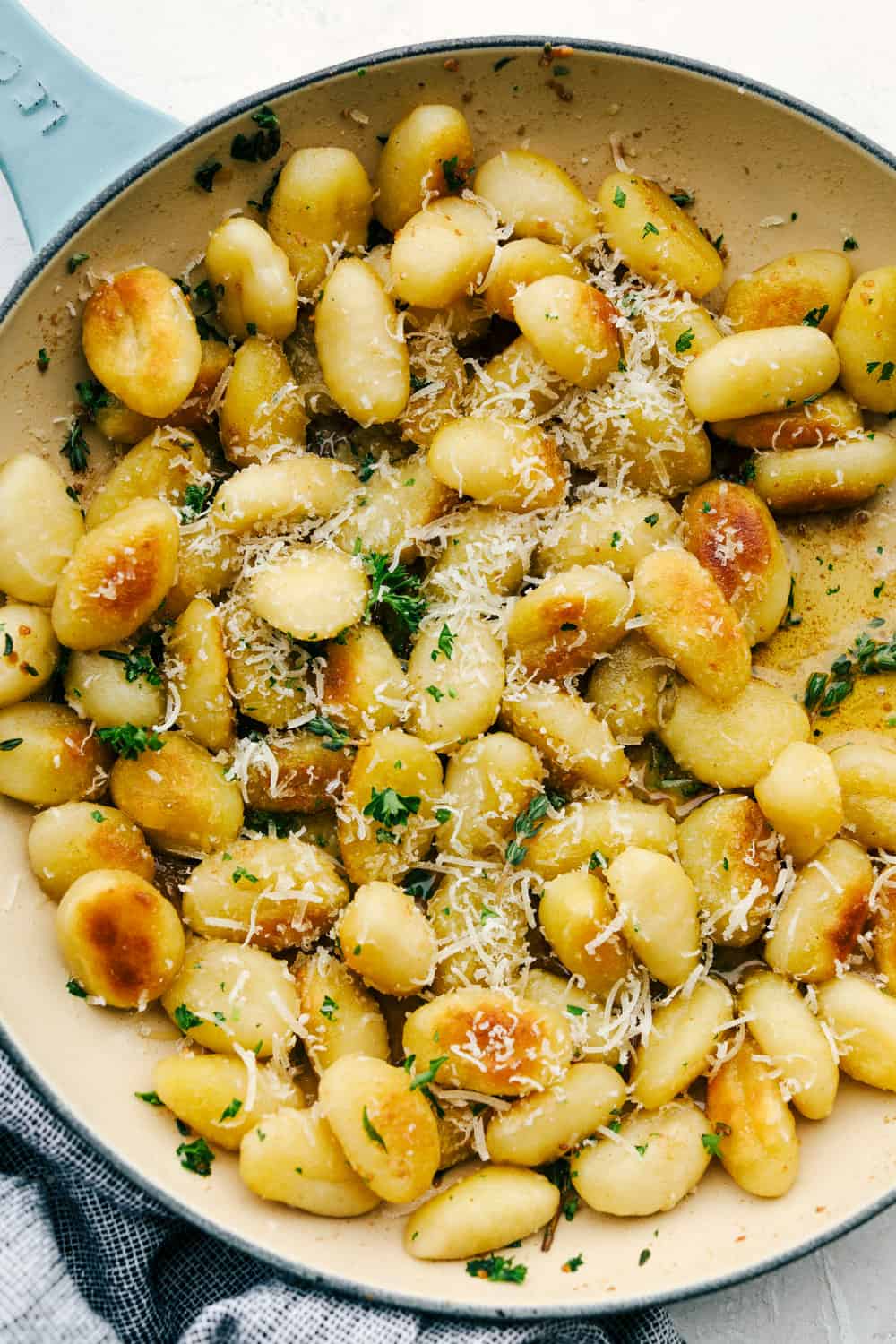 Brown Butter Garlic Fried Gnocchi are tender morsels tossed in a buttery herb sauce you are going to love! Super easy and quick, this is a perfect dish for busy nights or unexpected guests! Fried gnocchi with browned butter in a skillet.