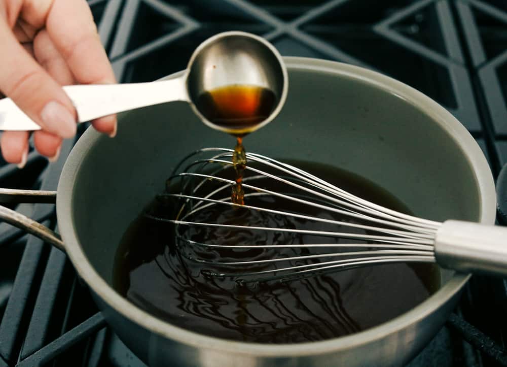 Homemade Maple Syrup is super easy and way better than store bought! Making your own syrup is going to change the way you do breakfast! Adding ingredients to a saucepan to make maple syrup.