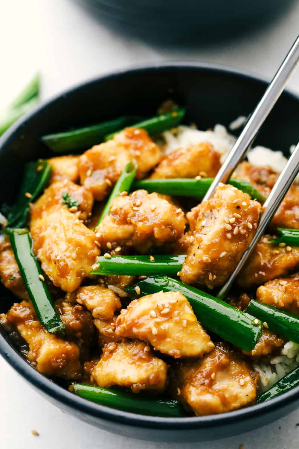 Mongolian Chicken is coated chicken tossed in a sweet savory sauce that is better than take out!ย This simple recipe is the beginning to tasty dinner in minutes.