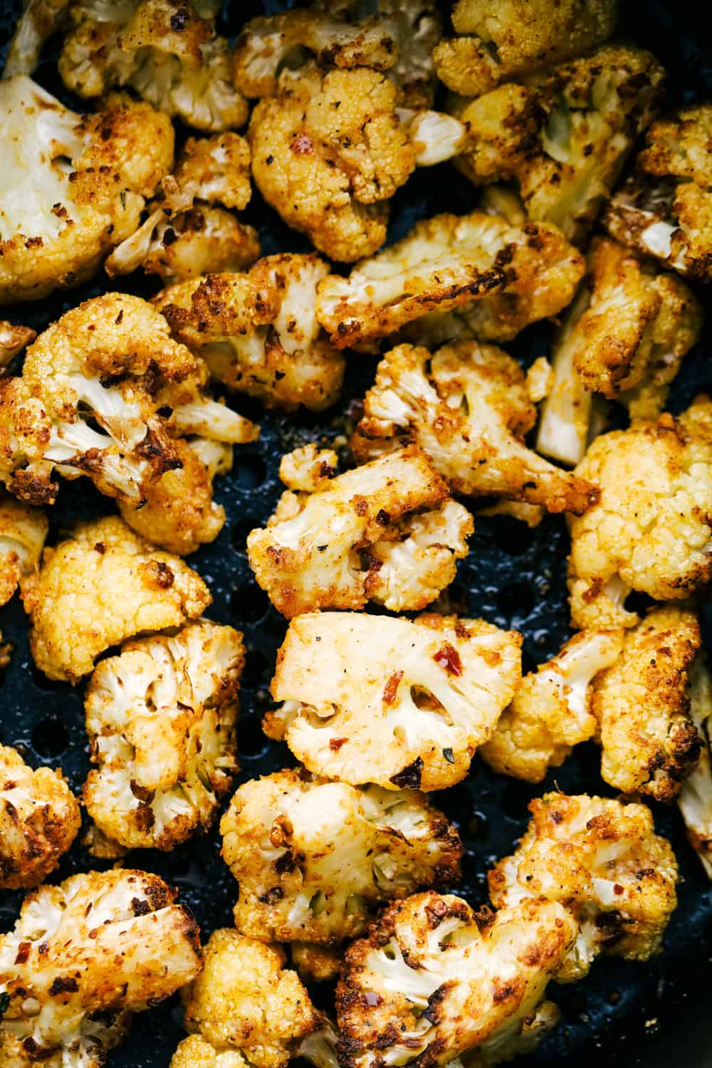 Air Fryer "Roasted" Cauliflower is perfectly tender, crisp and full of amazing flavor. You are going to love how easy it is to make this delicious side dish! Roasted cauliflower in the air fryer.