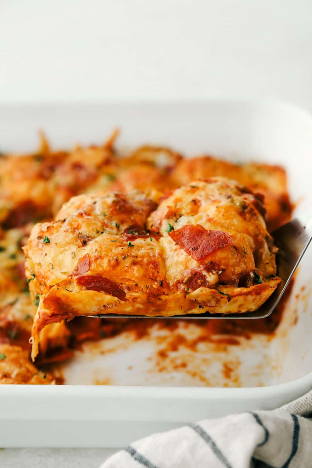 Bubble Pizza is what you make when you want something cozy, cheesy, and easy. Think pizza meets pull-apart bread with zero rolling, stretching, or takeout guilt. Scooping out a slice of Bubble pizza.