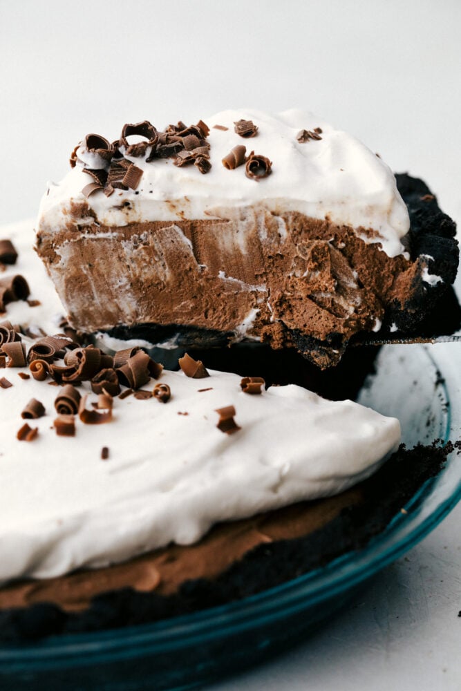 No Bake Chocolate pie is silky smooth, rich and incredibly indulgent! The perfect option when you want something exquisite, but don't want to heat up the kitchen! Serving up a slice of chocolate pie.