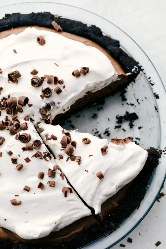 No Bake Chocolate pie is silky smooth, rich and incredibly indulgent! The perfect option when you want something exquisite, but don't want to heat up the kitchen! Chocolate pie with a slice missing and chocolate curls on top.