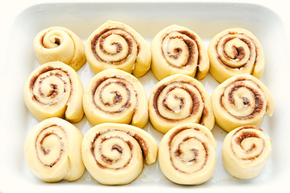 Overnight Cinnamon Rolls is a recipe you need in your arsenal. They make waking up worth it in the morning! Raised cinnamon rolls ready to bake.