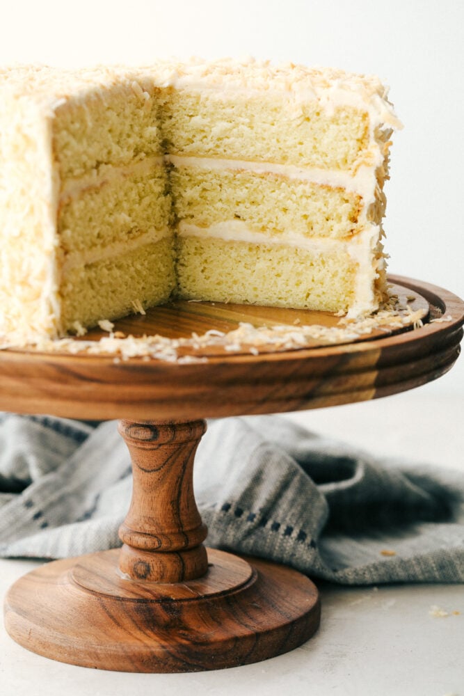 Coconut Cream Cake with Coconut Cream Cheese Frosting is super moist and delicious with the best coconut cream cheese frosting! This cake will be devoured and loved by all! Sliced coconut cake, you can see all the layers.