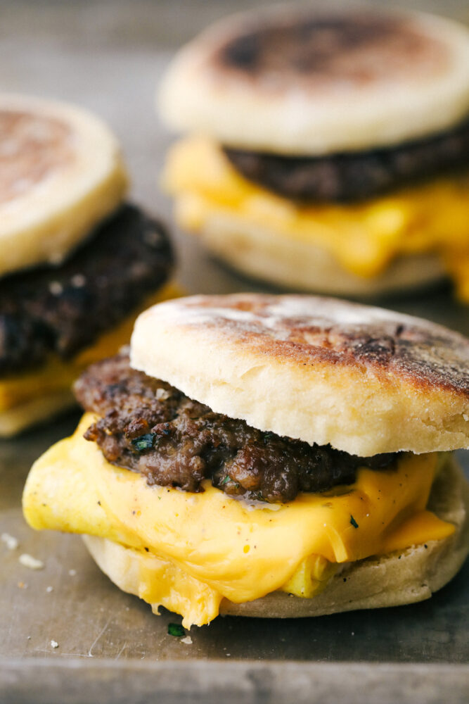 Homemade English Muffin Breakfast Sandwiches are the best thing to happen to your mornings! These are super easy, freezer friendly, and absolutely delicious! Egg, sausage and cheese on an English muffin.