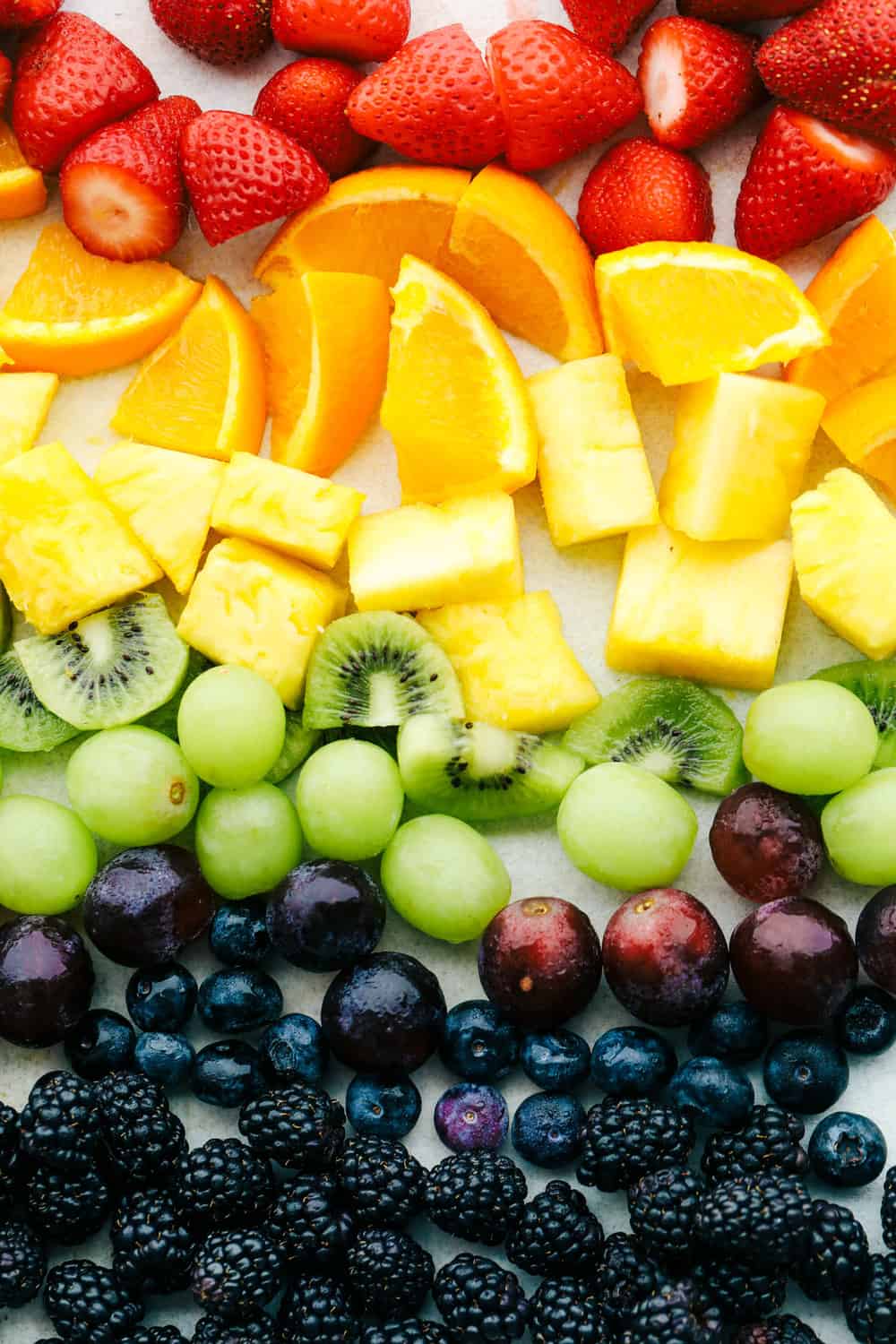 Fresh Rainbow Fruit Skewers are a super easy and fun sweet treat. Fruit skewers are a colorful, fun and yummy way to eat the recommended servings of fruit! Prepared variety of fruit ready to use.