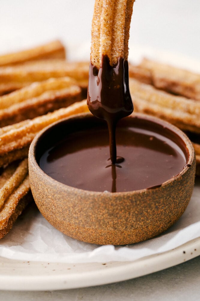 All I have to hear is the word, Churros, and my mouth starts to water. Light fluffy dough is fried and then covered in cinnamon and sugar, totally heavenly! Dipping a churro in chocolate sauce.