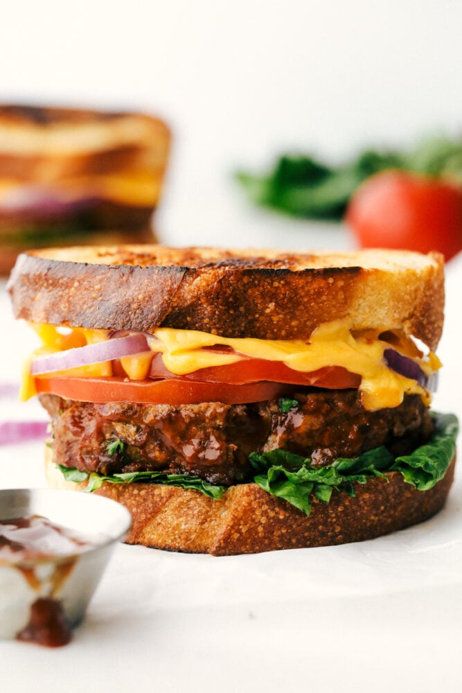 Meatloaf Sandwiches are the real reason we make meatloaf to begin with! They are juicy, full of flavor and perfect for lunch or dinner! Grilled Meatloaf sandwich with cheese, tomato and lettuce.