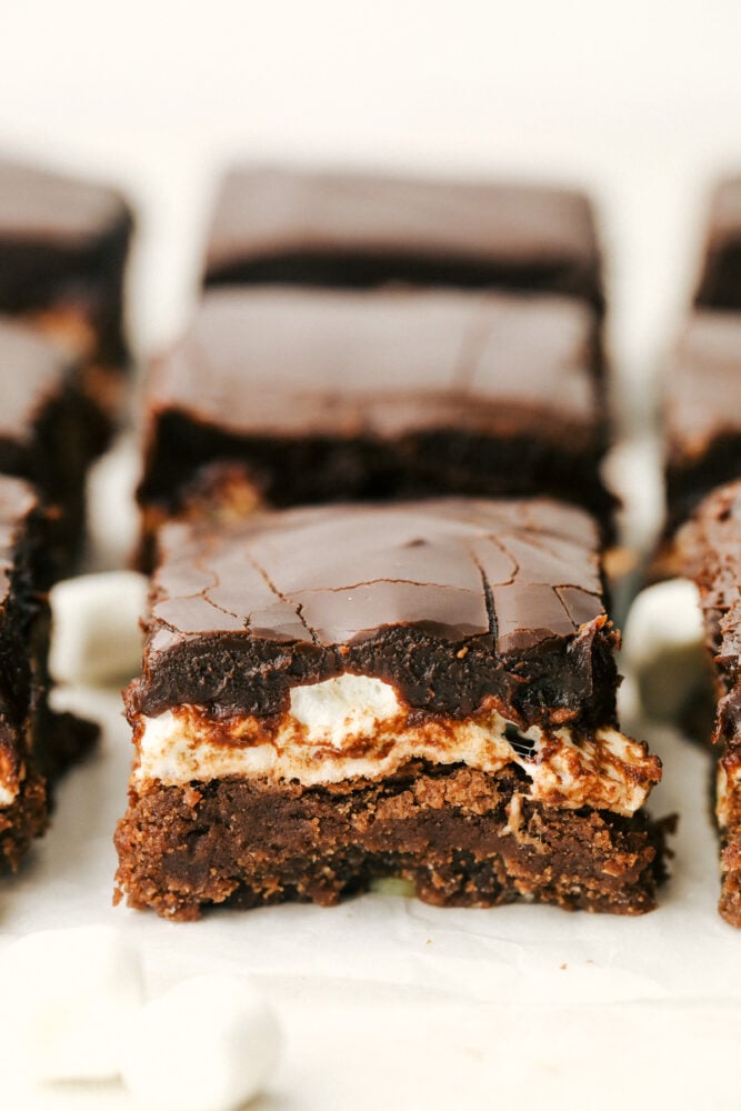 Mississippi Mudslide Bars are a chewy brownie base, topped with a fluffy marshmallow layer, and finished off with a rich and silky chocolate frosting. They are so addictive! Mississippi Mudslide Bars lined up.