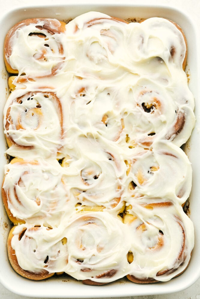 Overnight Cinnamon Rolls is a recipe you need in your arsenal. They make waking up worth it in the morning! Cinnamon rolls covered in cream cheese frosting.
