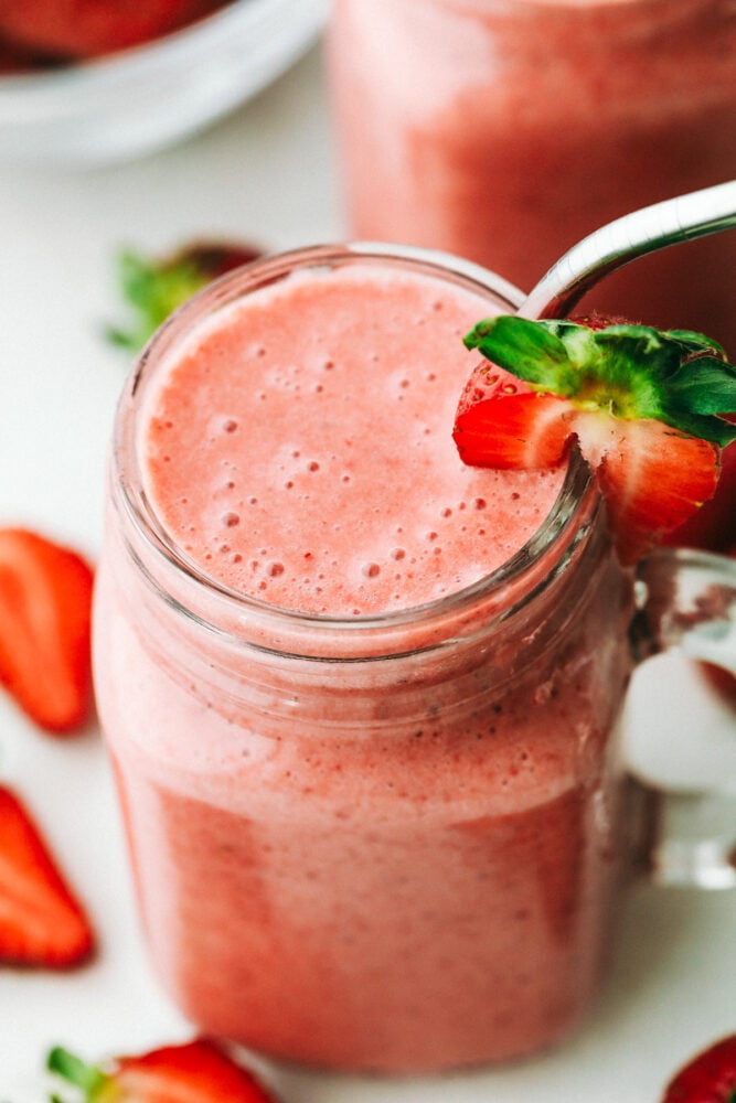 Strawberry Smoothie is creamy, refreshing, and the perfect way to satisfy your sweet tooth! It tastes just like a milkshake, but more nutritious! Strawberry smoothie in a jar and ready to drink.