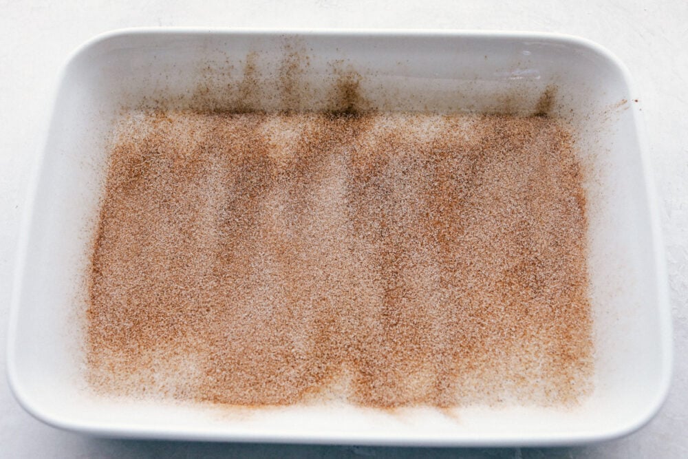 spreading the cinnamon and sugar on the bottom of the pan.