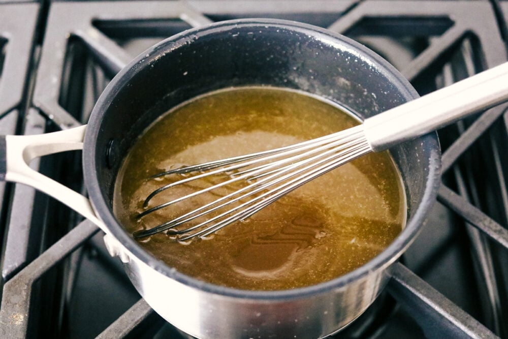 I am not joking when I say these are to die for Cornbread pancakes with honey butter syrup. These may well be the most amazing pancakes you will ever have! The honey butter syrup in a pan on the stove.