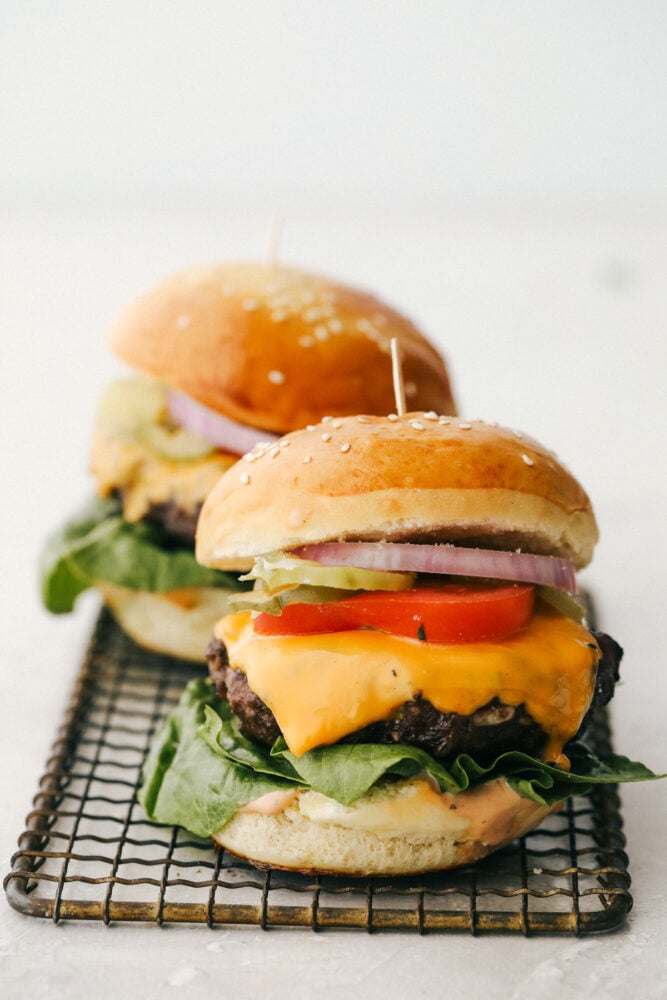 Grilled Beef Burgers are one of the most amazing things you can sink your teeth into, especially when they are done right! Be prepared, because these will be the best burgers you have ever had! Hamburgers with all the toppings ready to be served.