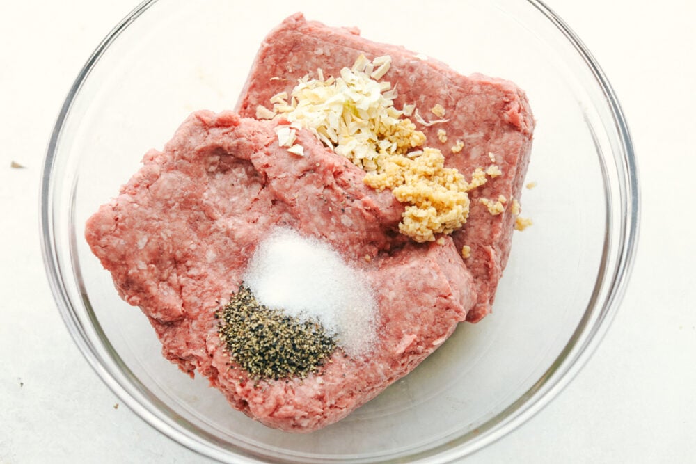 Grilled Beef Burgers are one of the most amazing things you can sink your teeth into, especially when they are done right! Be prepared, because these will be the best burgers you have ever had! All the hamburger ingredients in a bowl ready to be mixed.