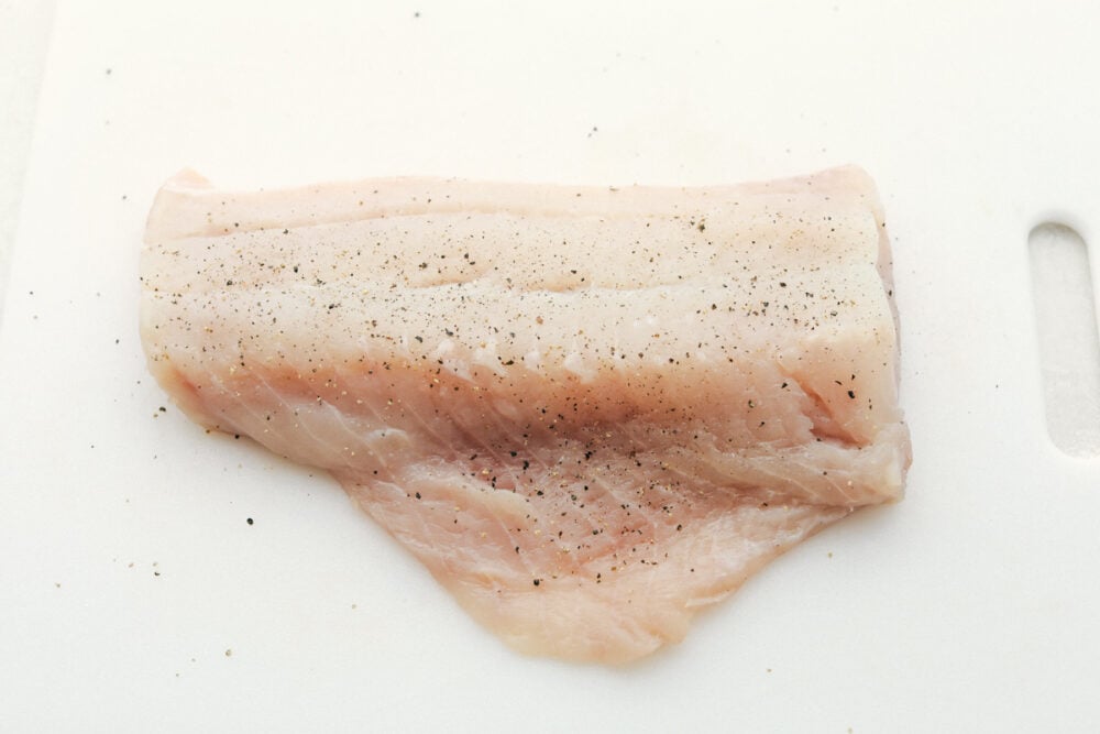 This Grilled Cajun Garlic Butter Cod is the only recipe you will need this summer! The cod is tender and juicy and the flavor is spicy and buttery, it's insanely delicious! Seasoning raw cod.