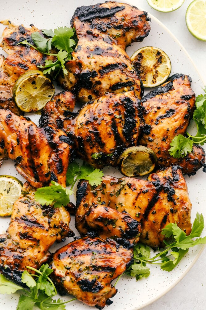 This grilled honey lime cilantro chicken is made for summer nights. It’s fresh, a little sweet, a little tangy, and packed with flavor. I make this on repeat when I need something easy that still feels like a real dinner. The grilled honey lime cilantro chicken on a white platter.