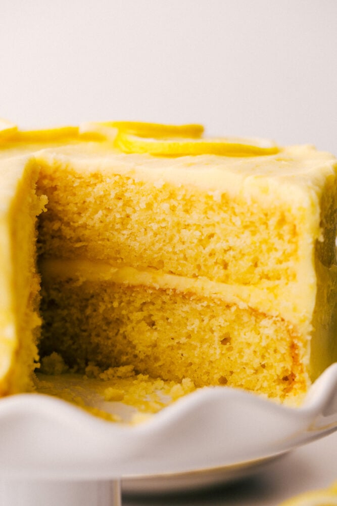 Lemon Cake is everything you want in a sweet, yet zingy cake! Tender moist layers of refreshing lemon cake are smothered with a tart but sweet frosting. Lemon cake with layers and lemon frosting.
