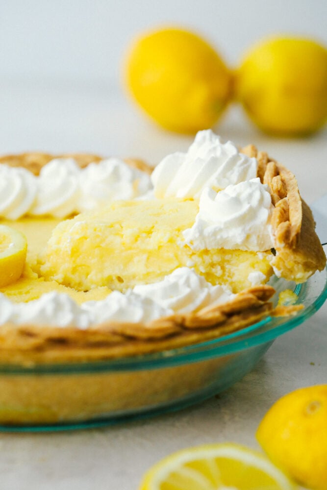 Lemon Pie is sweet, but a bit tart and totally refreshing! The perfect zingy, light, summertime dessert! Serving up a piece of lemon pie.