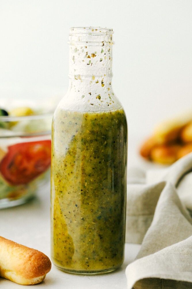Olive Garden Salad Dressing is one of the best things at the restaurant, and now you can make it at home! Instead of having to go to the restaurant, you can have this tasty dressing anytime you crave it in the comfort of your own home! Olive garden salad dressing in a glass jar,