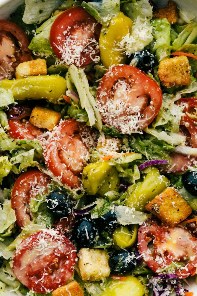 Copycat Olive Garden Salad is one of my all-time favorite restaurant salads, and now you can make it right at home. Itโs bright, zesty, and packed with that fresh, irresistible flavor everyone loves. Up close picture of the copycat Olive Garden salad all mixed together.