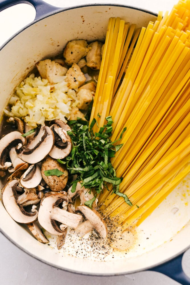 Chicken and Mushroom Fettuccine Alfredo is an easy weeknight or weekend meal made even faster if you have leftover chicken. One-pot means keeping this simple while everything is simmered together. All the ingredients in one pot.
