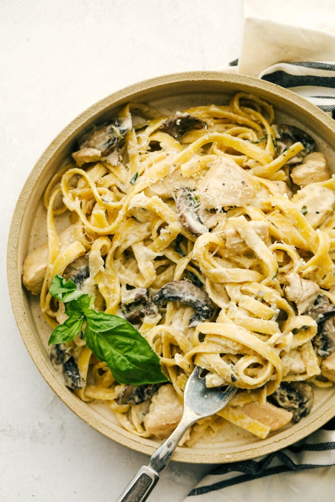 One-Pot Chicken and Mushroom Fettuccine Alfredo - A delicious and easy weeknight or weekend meal! Everything is simmered in just one pot, fewer dishes! Chicken and Mushroom Fettuccine Alfredo is an easy weeknight or weekend meal made even faster if you have leftover chicken. One-pot means keeping this simple while everything is simmered together.