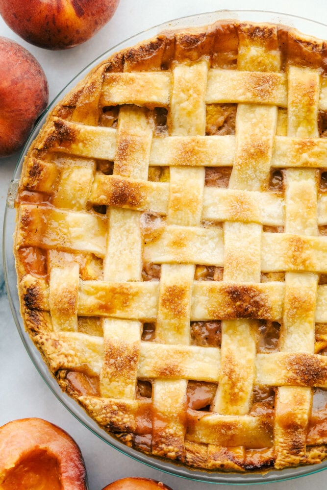 This Homemade Peach Pie is a bit of summer paradise on your plate! Flakey buttery crust is filled with a luscious sweet peach filling that is perfect with a scoop of vanilla ice cream. Baked peach pie.