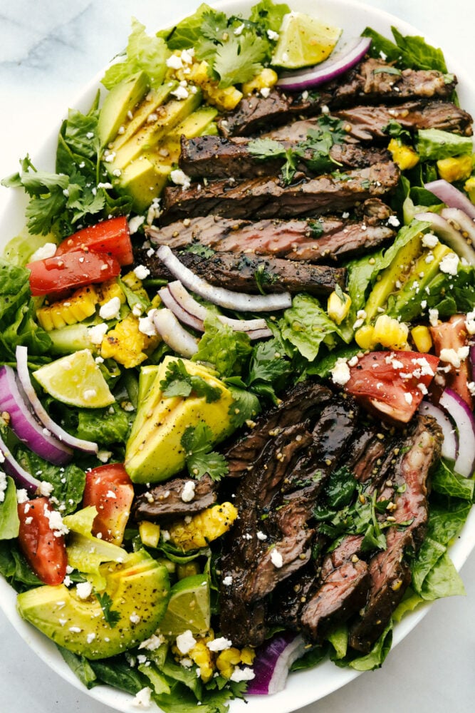 Juicy skirt steak, fresh veggies, and feta cheese- all tossed in a delicious tangy glaze. Steak salad with honey balsamic dressing is a mouthwatering meal infused with bold, savory flavor! Skirt steak tossed in a salad with assorted vegetables.