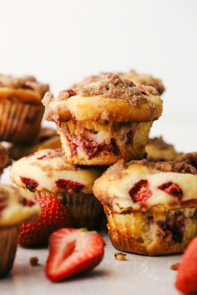 Strawberry Cheesecake Streusel Muffins are going to get you out of bed in the morning! These strawberry muffins are tender and sweet and full of flavor! Strawberry streusel muffins stacked on top of each other.