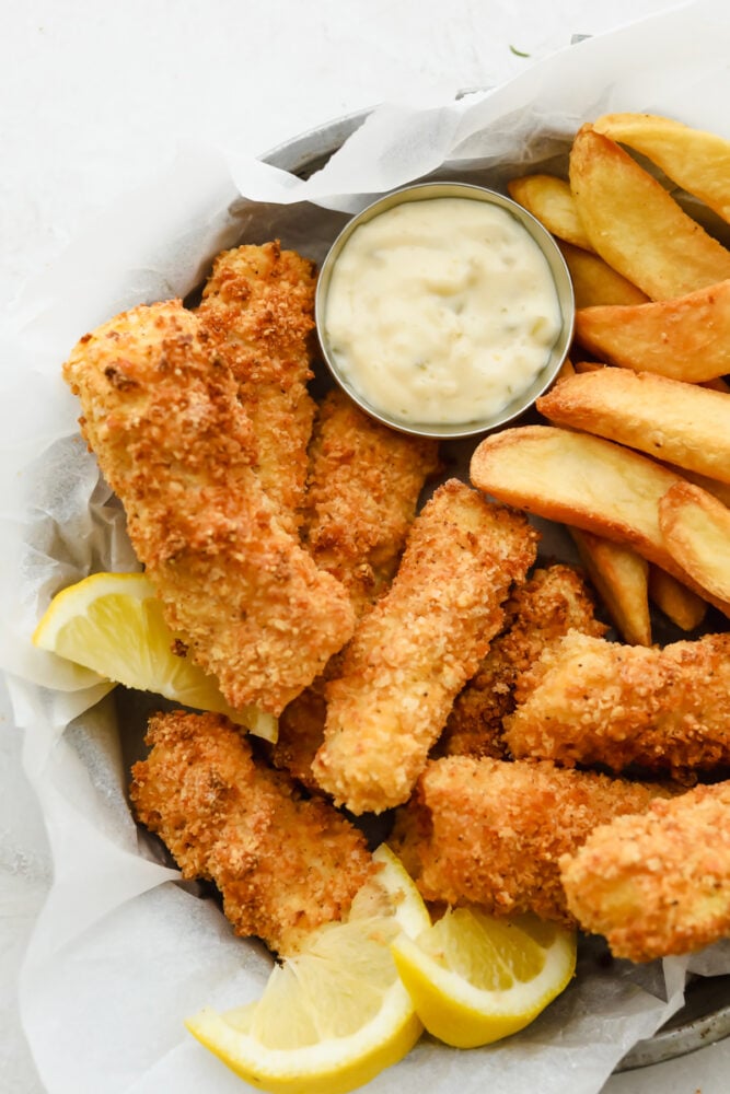 These air fryer fish sticks are going to rock your family's world. Never again will you make fish sticks from a box, these are insanely delicious! Air fryer fish sticks with french fries and tartar sauce.