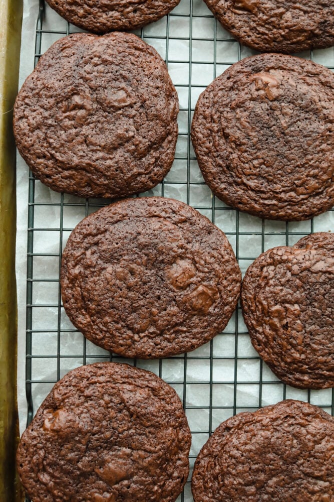 Brownie Cookies are the chewy, fudgy treat that you are not going to be able to get enough of. A combination of two of my favorite desserts, you won't believe how ooey gooey and perfect these are! Baked brownie cookies on baking sheet.