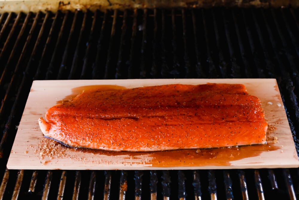 Smoky, woodsy flavors meet summery honey and lime in this melt-in-your-mouth salmon recipe! You are not going to be able to get enough of this irresistible Cedar Plank Honey Lime Salmon! Cooked salmon with honey lime glaze added on top.